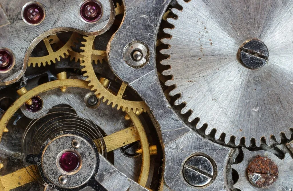 Detailed close-up of interlocking gears and cogs in a complex mechanical system.